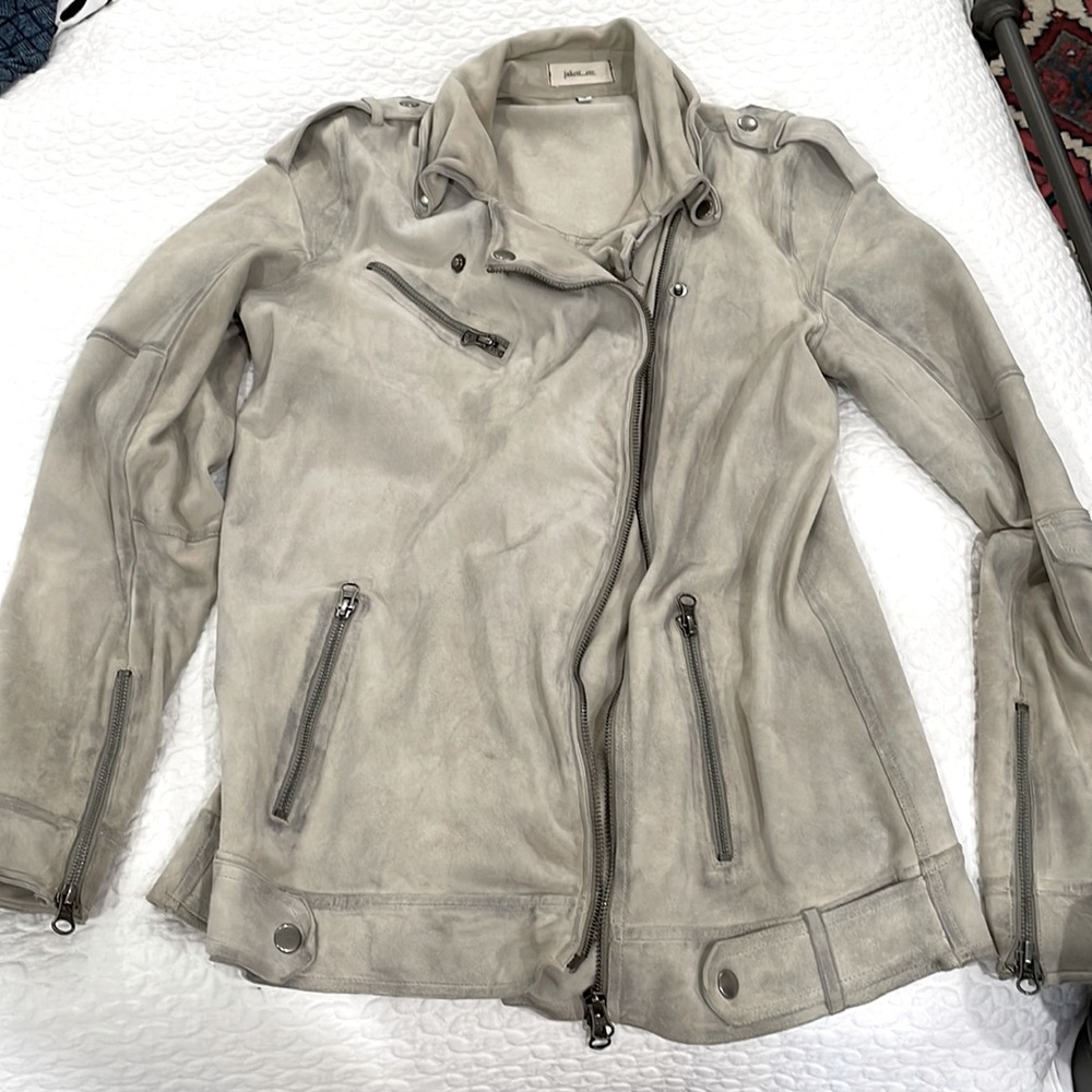 Genuine distressed leather jacket with relaxed fit.